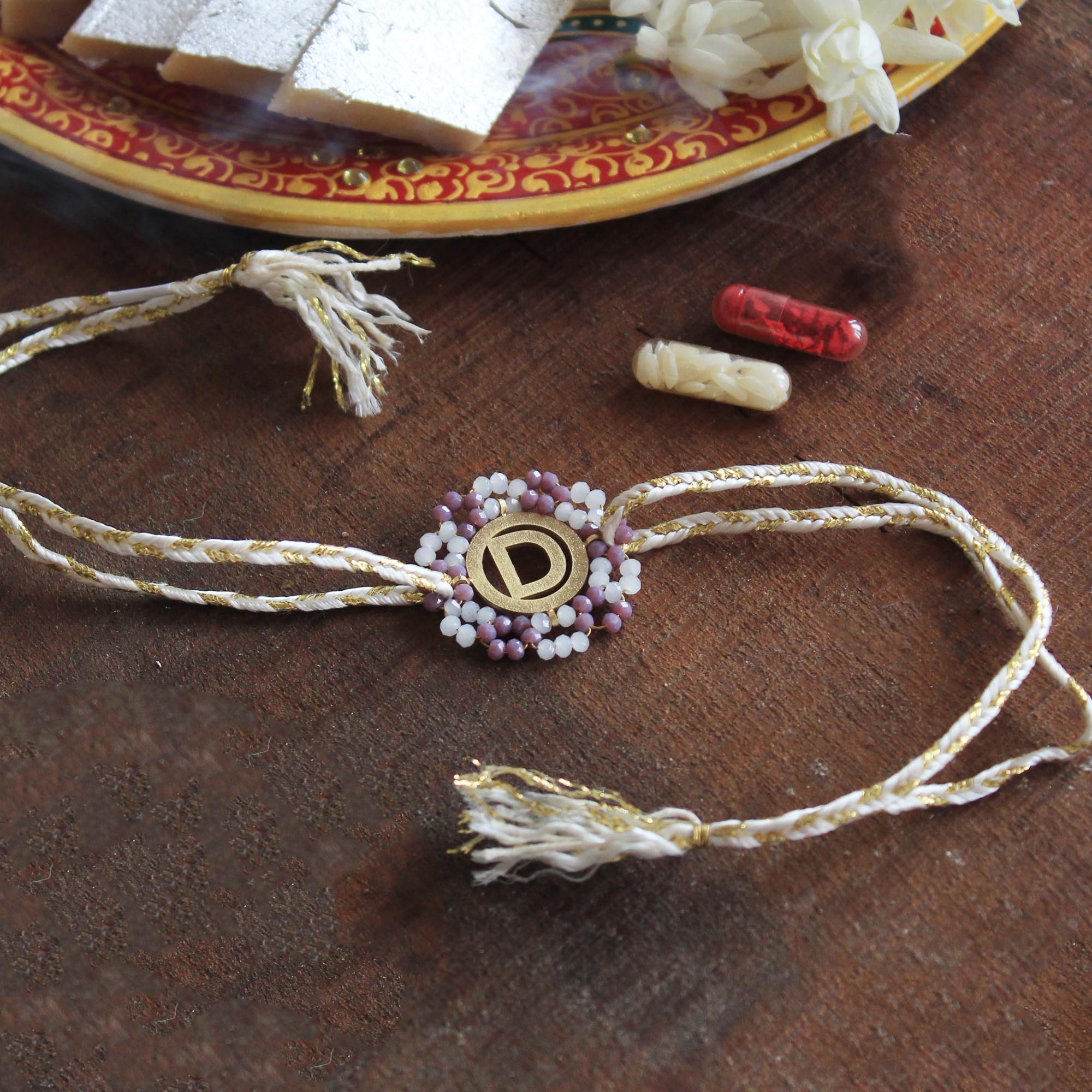 Initial Mauve Rakhi with Roli Chawal